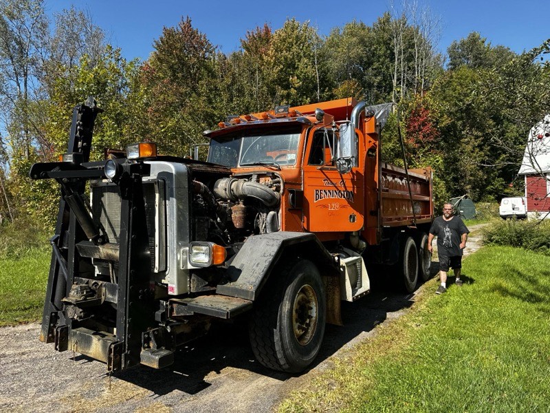 Excavator with hydraulic thumb loading material on job site in Pulaski NY