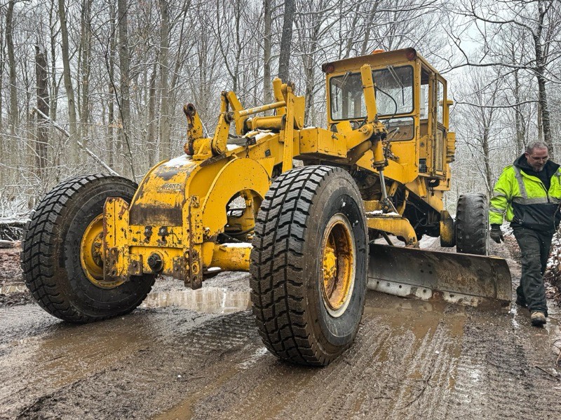 Excavator digging retention pond for stormwater management system